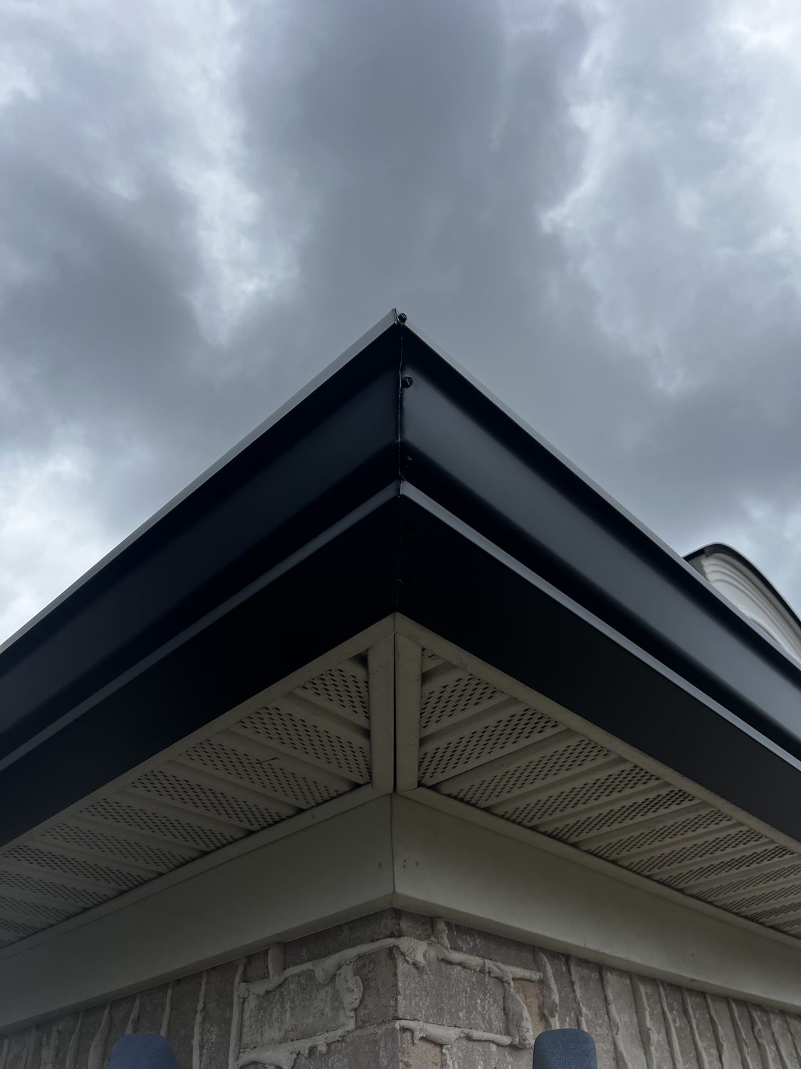 Clean gutter miter on a brick and stone home by Gutter And Covers, Cookeville