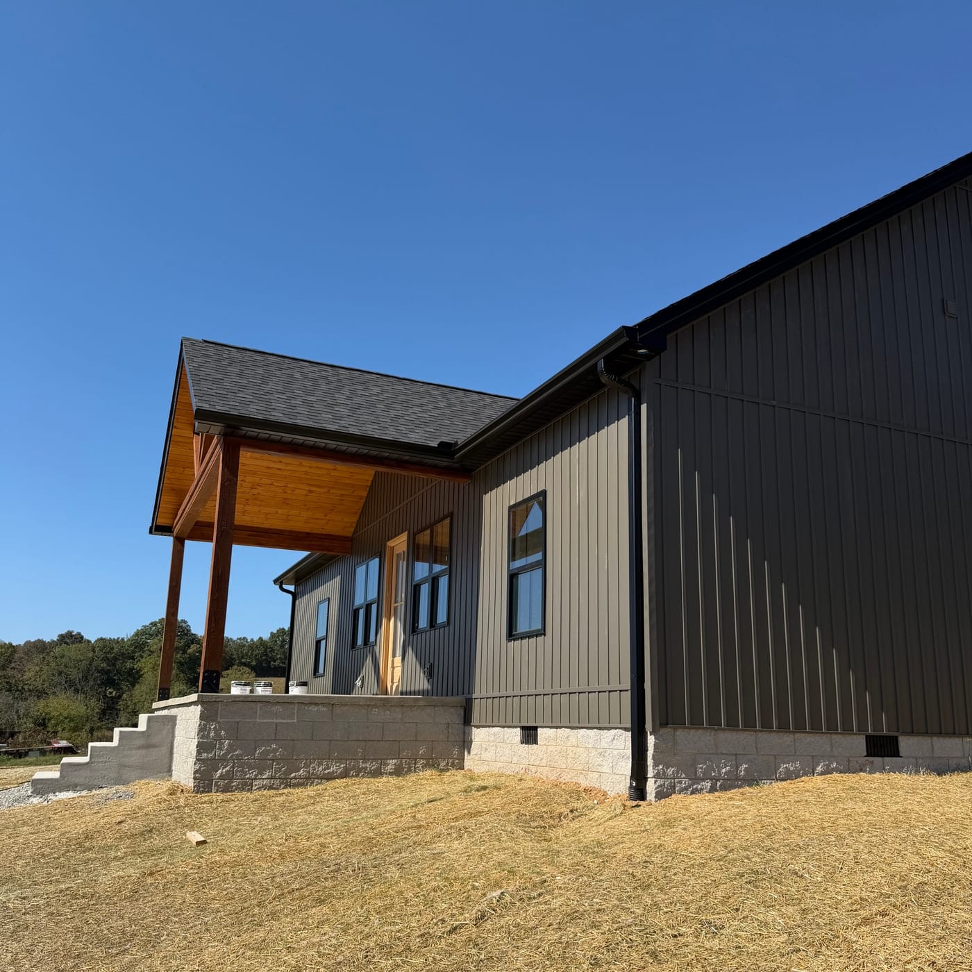 Dark gutter line on a new home with a timber porch by Gutter And Covers, Cookeville